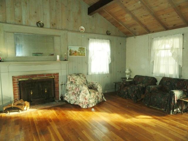 61 Lawrence Road Dennis Port, MA 02639 - Photo 4 of 14 a living room with furniture and a fireplace