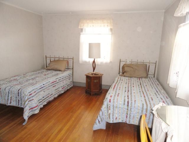 61 Lawrence Road Dennis Port, MA 02639 - Photo 9 of 14 a bedroom with a bed and wooden floor