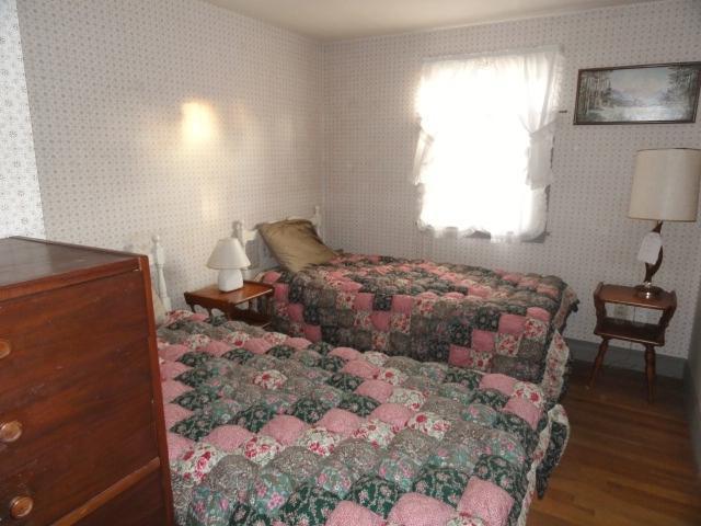 61 Lawrence Road Dennis Port, MA 02639 - Photo 10 of 14 a bedroom with a bed and wooden floor