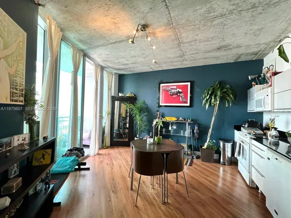 a view of a dining room with furniture window and wooden floor