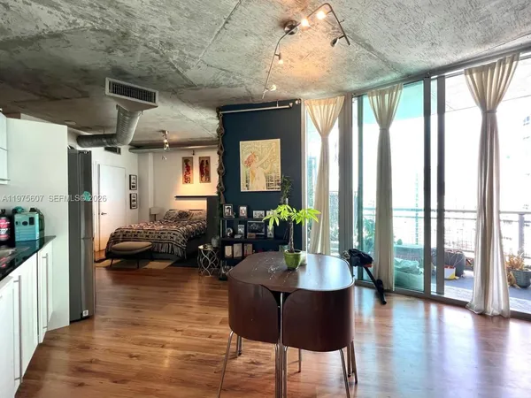 a living room with furniture or wooden floor and a large window