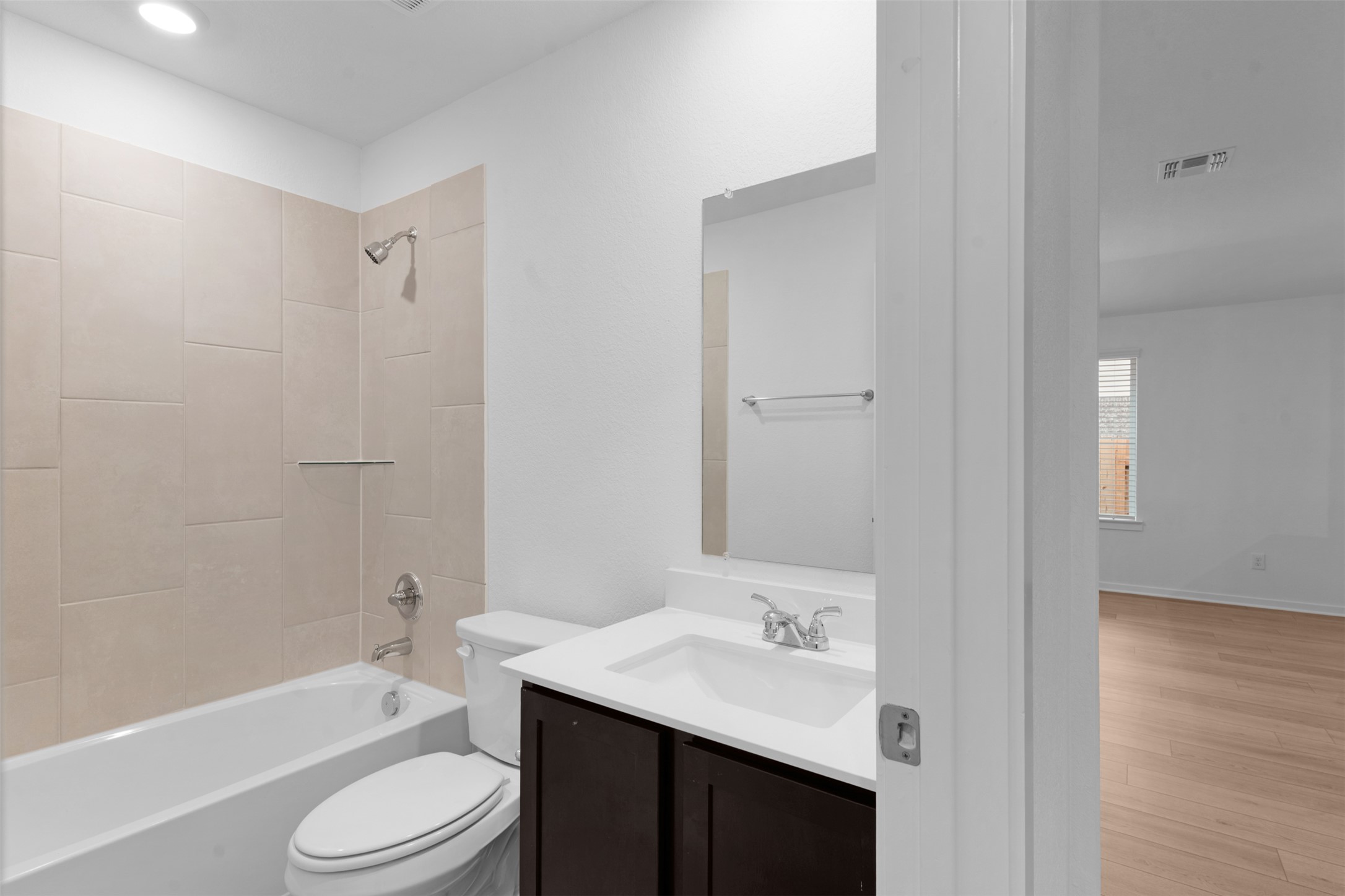 13721 Tucker Hedge Pass Elgin, TX 78621 - Photo 18 of 28 Bathroom featuring vanity, tub / shower combination, wood finished floors, and recessed lighting