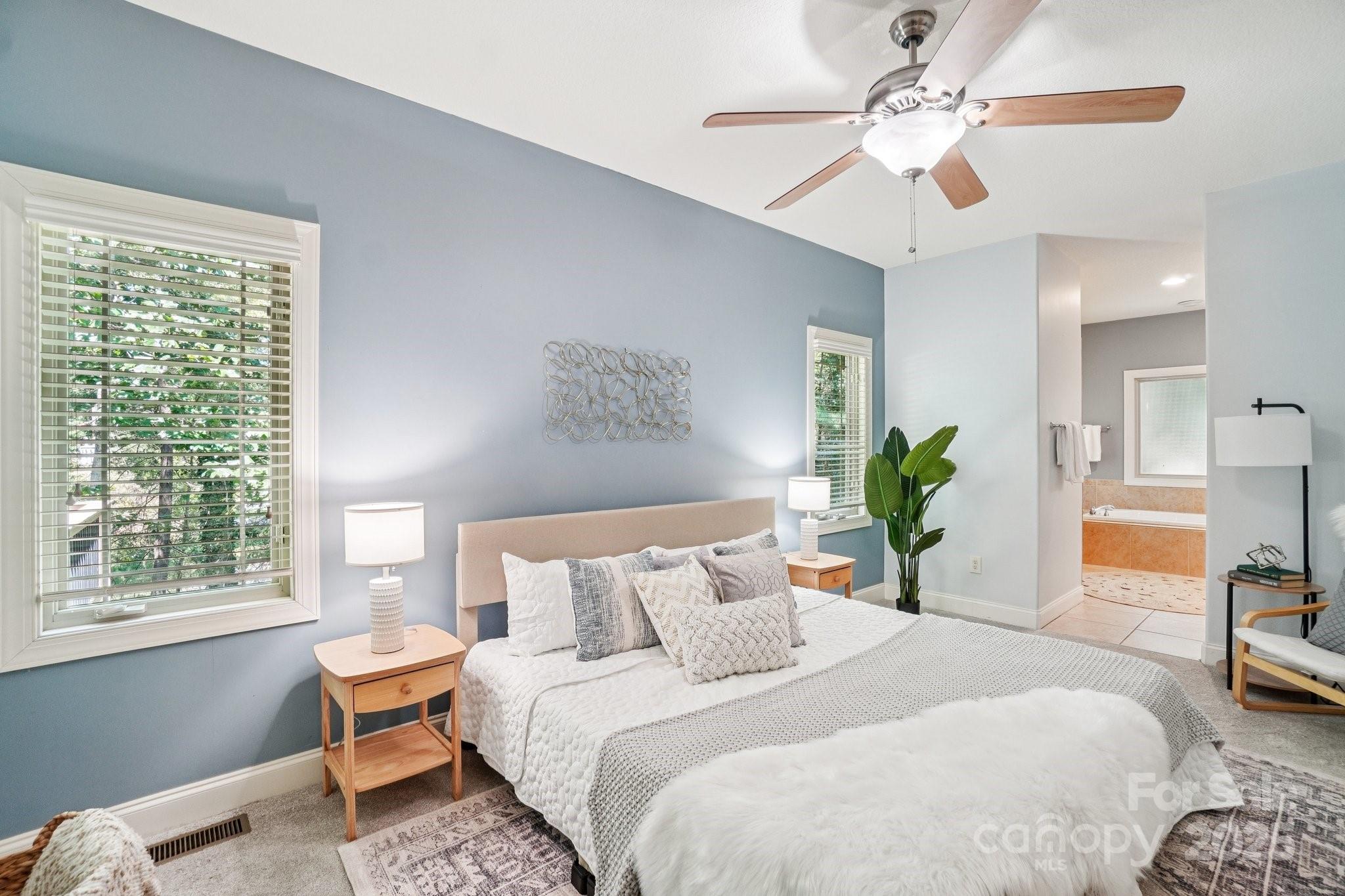 147 Cedar Lane Arden, NC 28704 - Photo 17 of 48 a bedroom with a bed and a chandelier