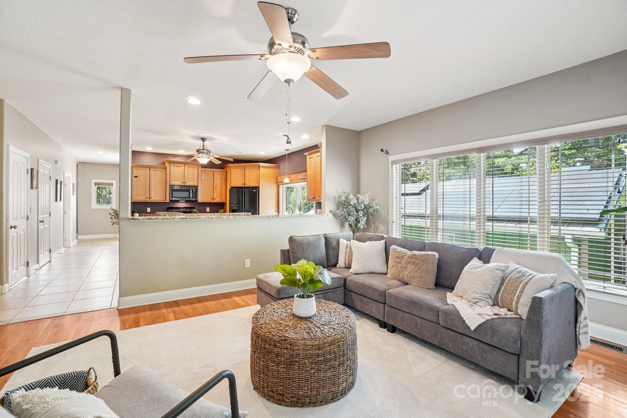 147 Cedar Lane Arden, NC 28704 - Photo 7 of 48 a living room with furniture and a large window with kitchen view