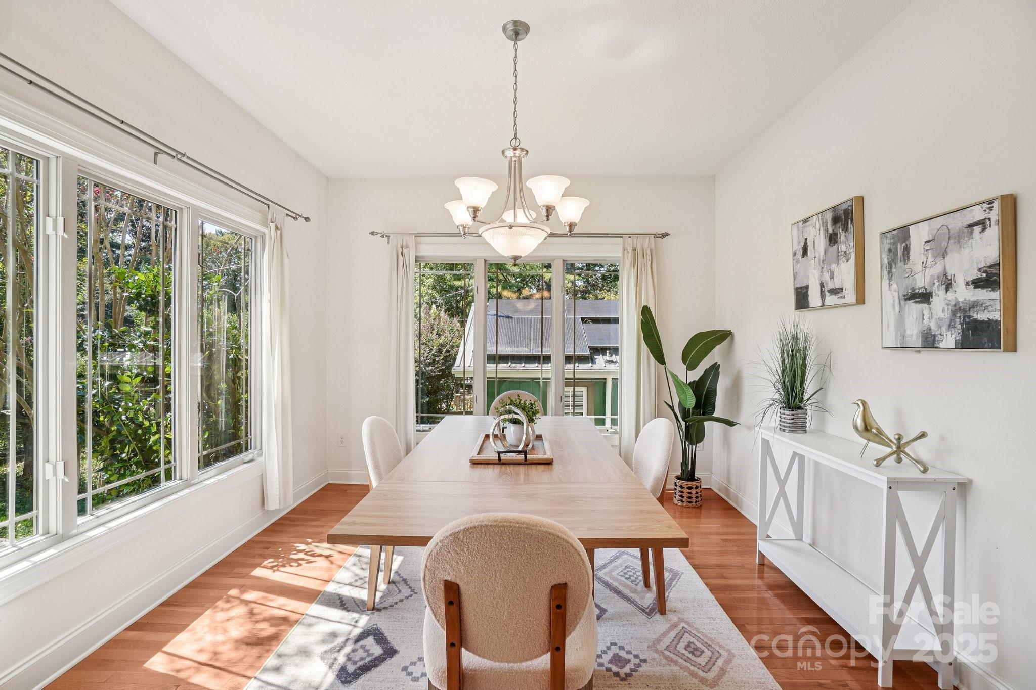 147 Cedar Lane Arden, NC 28704 - Photo 8 of 48 a view of a dining room with furniture a chandelier and wooden floor