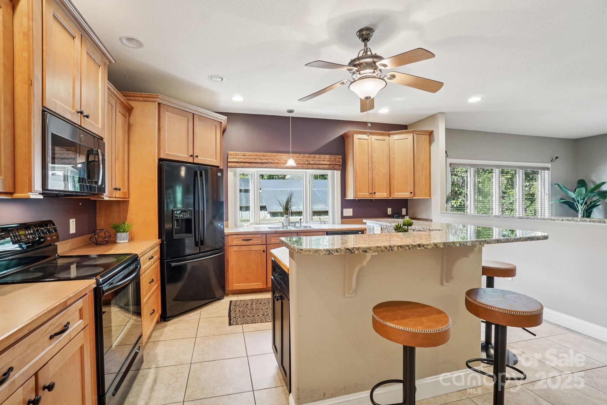 147 Cedar Lane Arden, NC 28704 - Photo 10 of 48 a kitchen with stainless steel appliances a stove refrigerator sink and cabinets