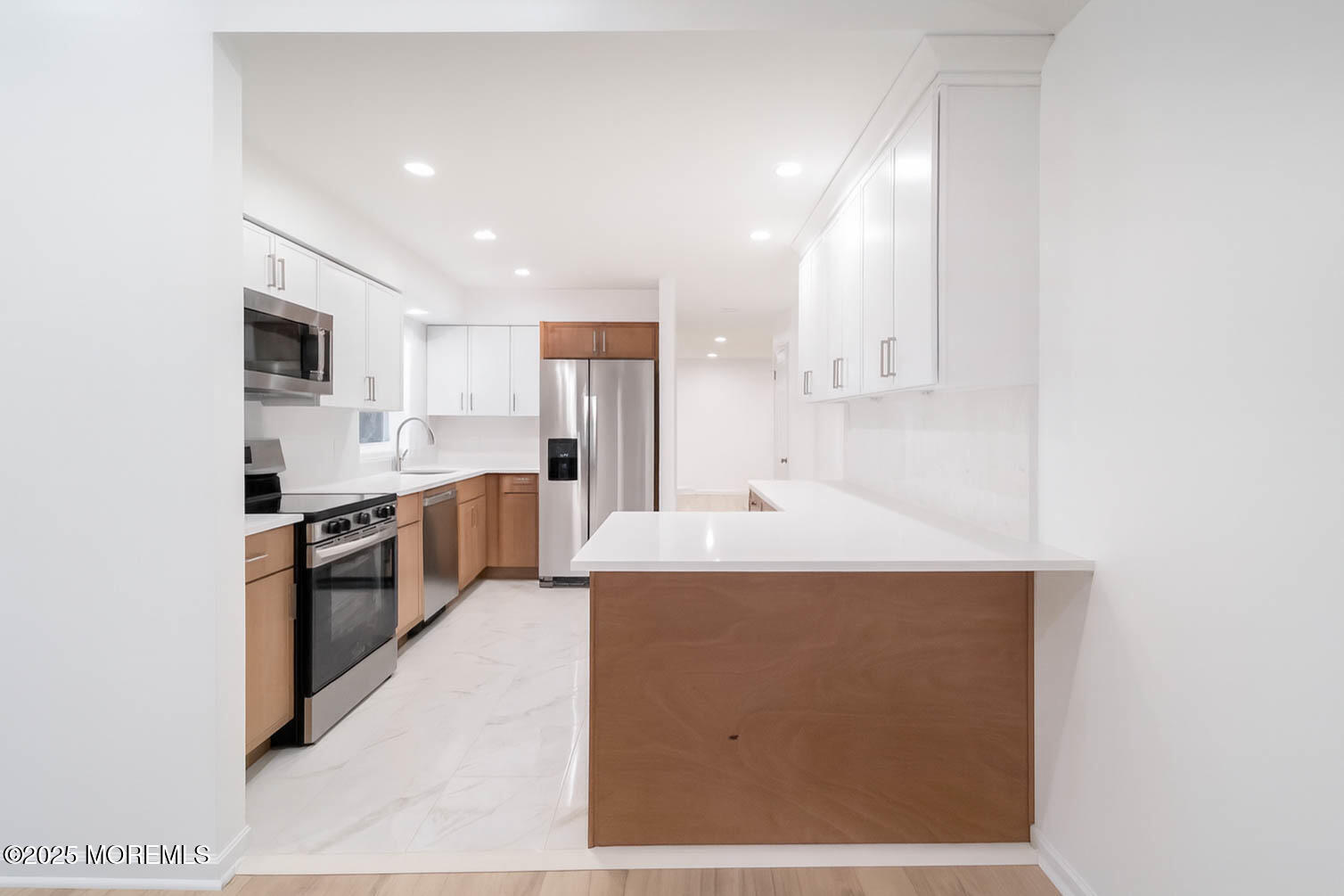 125 Shore Road Marmora, NJ 08223 - Photo 5 of 27 a large kitchen with a large counter top stainless steel appliances and cabinets