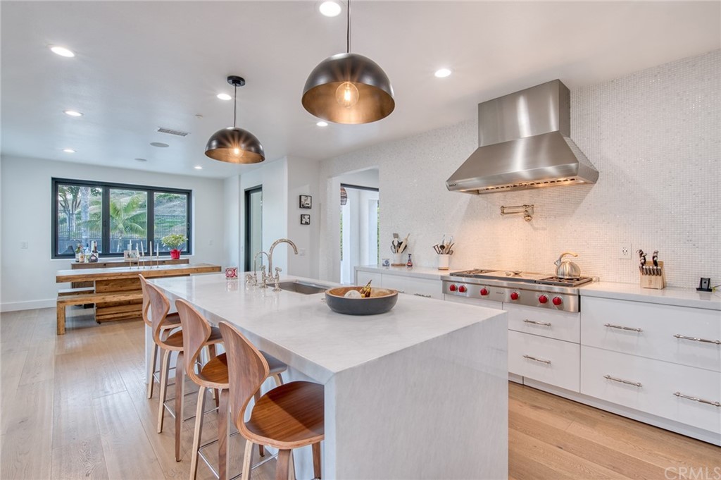 11 Epona Way Ladera Ranch, CA 92694 - Photo 9 of 41 a kitchen with stainless steel appliances a stove a table and chairs