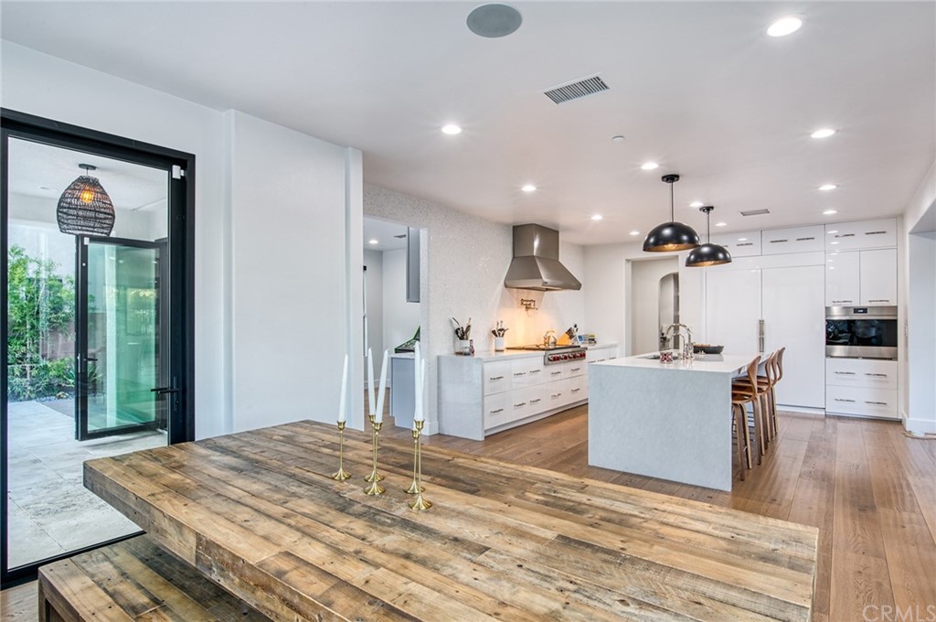 11 Epona Way Ladera Ranch, CA 92694 - Photo 10 of 41 a large white kitchen with wooden floor and a counter top space