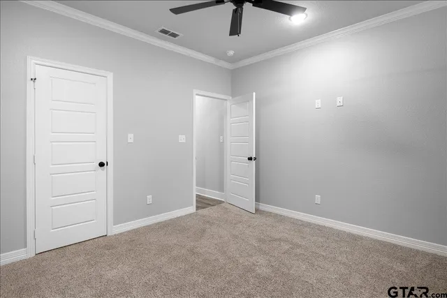 a view of walk in closet with empty racks