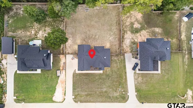 a view of a hallway with wooden floor and a bathroom