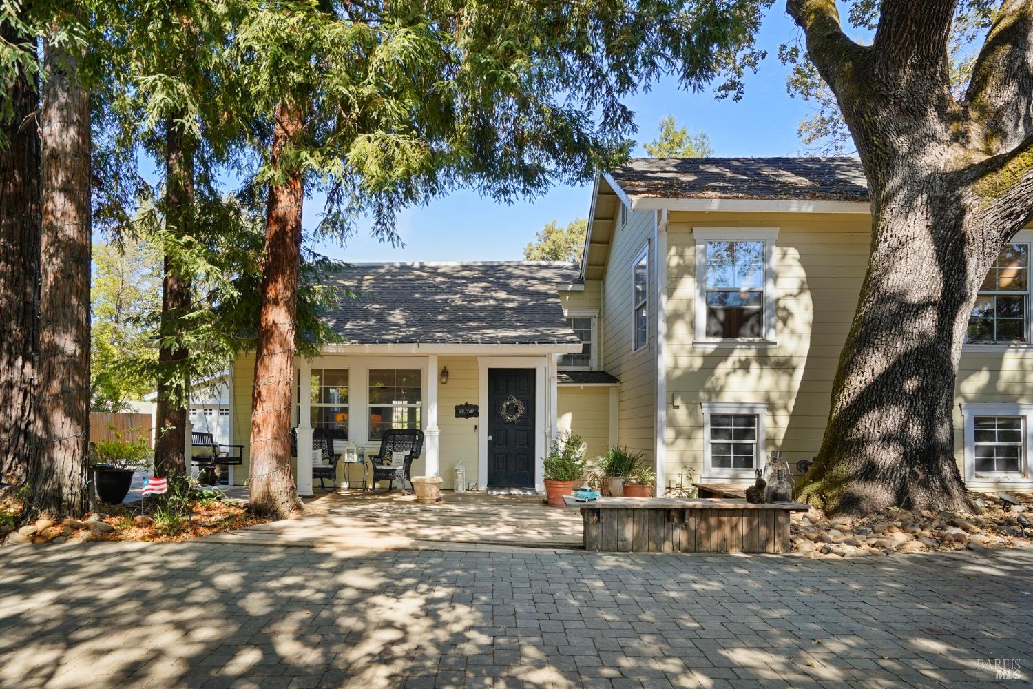 a view of a house with a tree in front