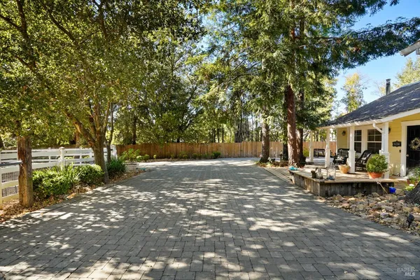 a view of backyard of house with outdoor seating and green space