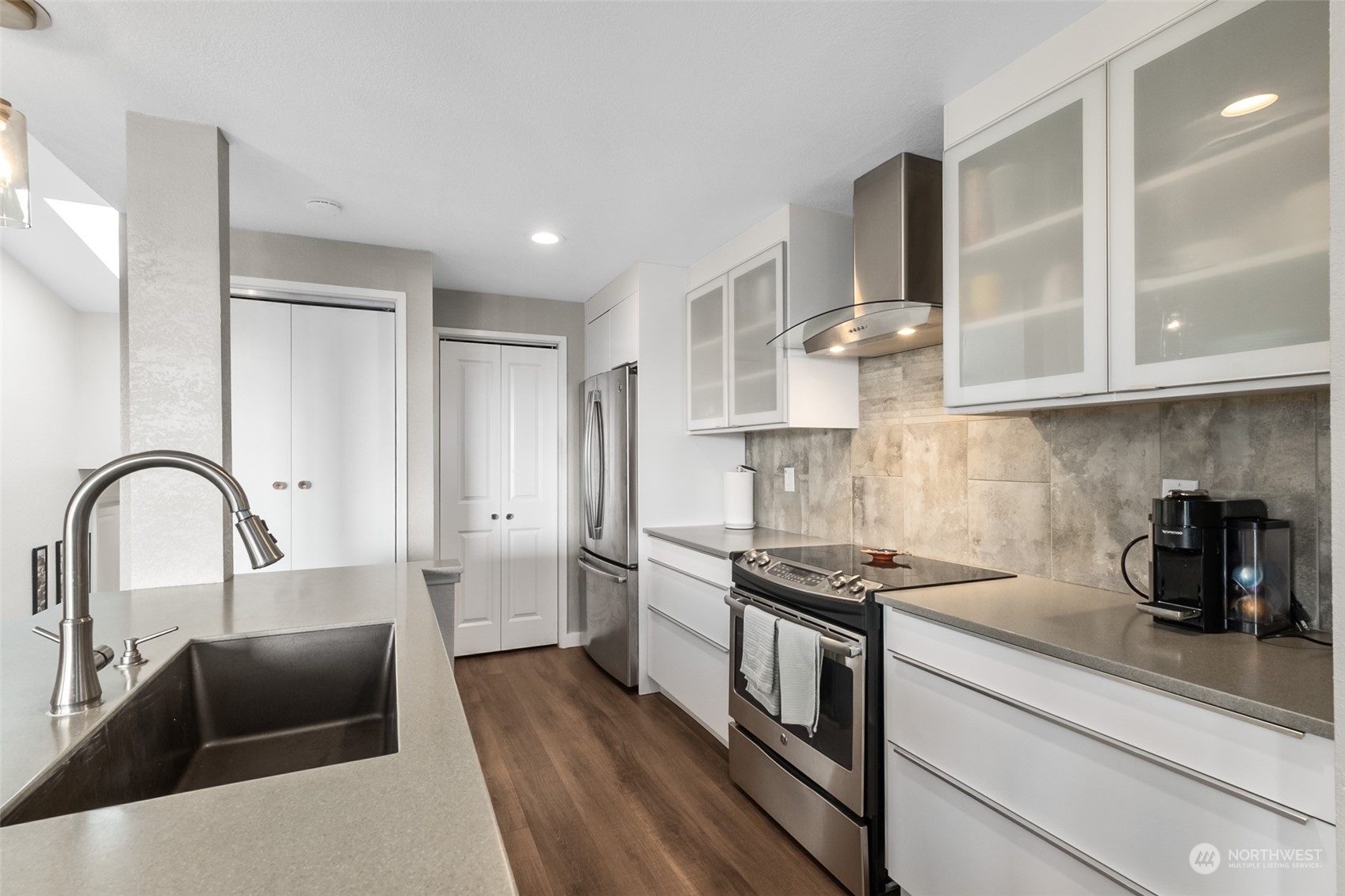 1501 Eagle Ridge Drive South, Unit G5 Renton, WA 98055 - Photo 12 of 23 a kitchen with stainless steel appliances granite countertop a stove a sink a refrigerator and cabinets