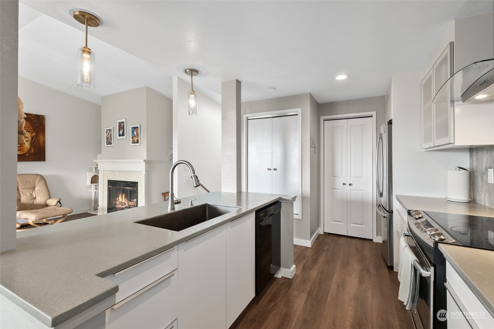 1501 Eagle Ridge Drive South, Unit G5 Renton, WA 98055 - Photo 13 of 23 a kitchen with stainless steel appliances a stove refrigerator sink and cabinets