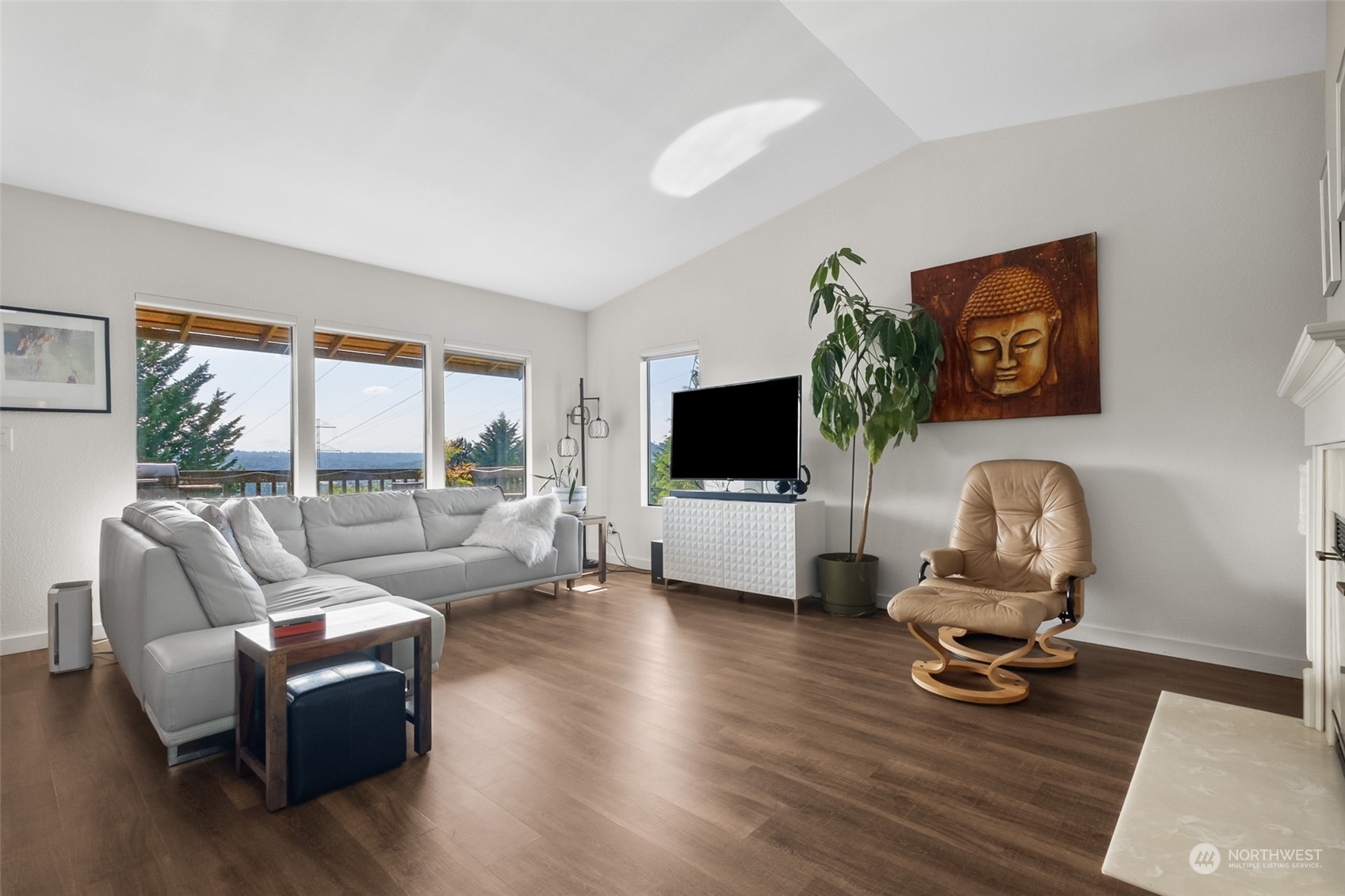 1501 Eagle Ridge Drive South, Unit G5 Renton, WA 98055 - Photo 7 of 23 a living room with furniture a flat screen tv and a floor to ceiling window