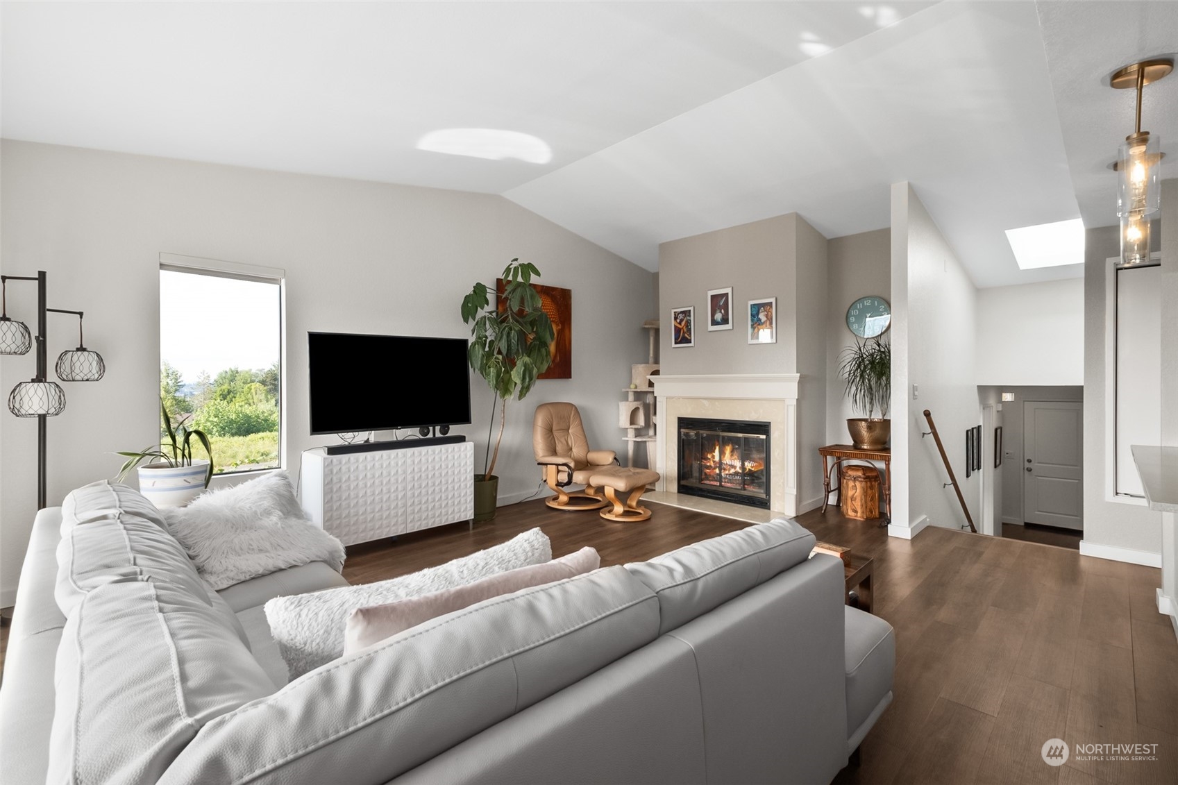 1501 Eagle Ridge Drive South, Unit G5 Renton, WA 98055 - Photo 8 of 23 a living room with furniture a flat screen tv and a fireplace