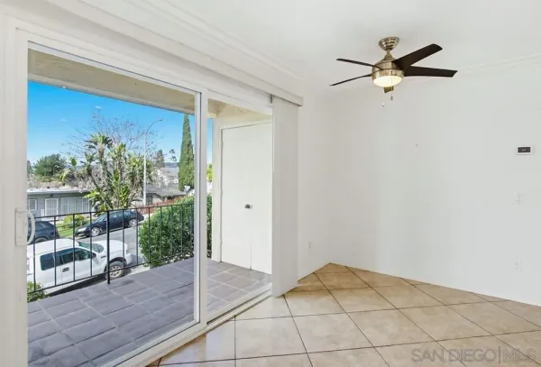 a view of a livingroom with a ceiling fan and wooden floor