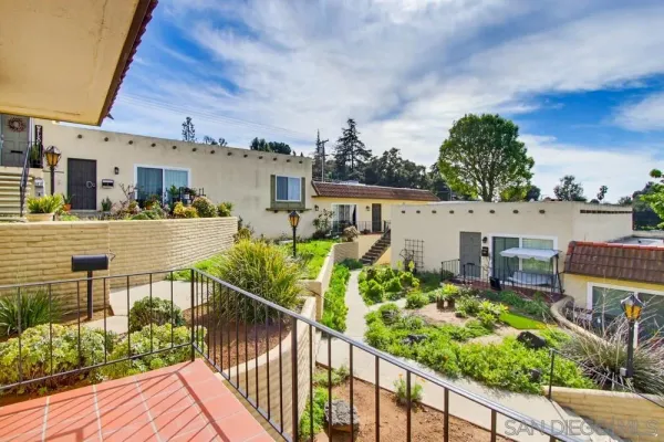 a view of a house with wooden fence