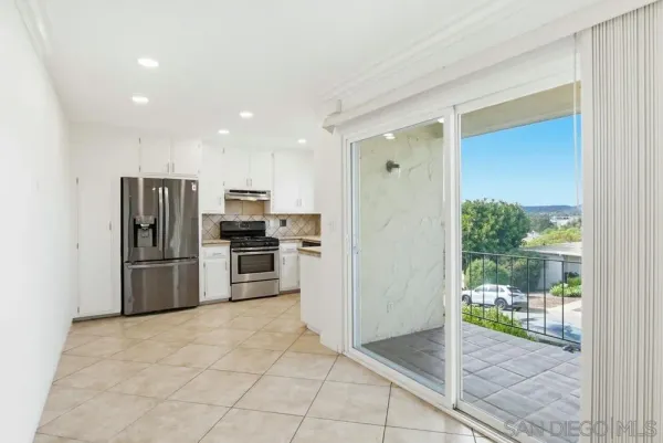 a kitchen with stainless steel appliances a refrigerator and a stove top oven