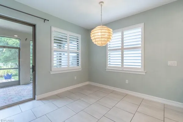 a large kitchen with a large counter top stainless steel appliances and cabinets