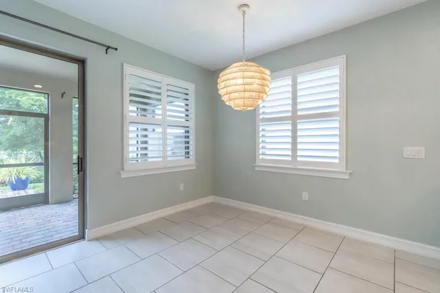 a large kitchen with a large counter top stainless steel appliances and cabinets