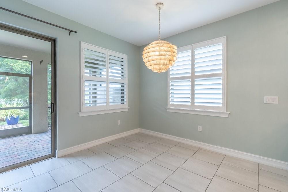 16374 Barclay Court Naples, FL 34110 - Photo 12 of 32 an empty room with windows and outdoor view