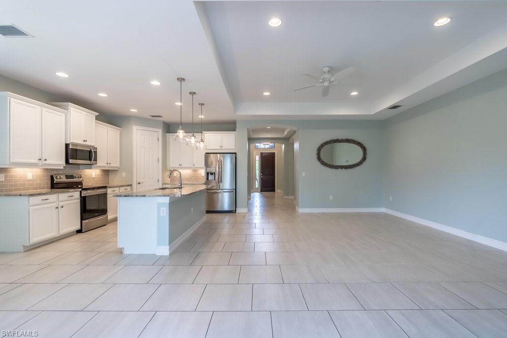 16374 Barclay Court Naples, FL 34110 - Photo 13 of 32 a large kitchen with a large counter top stainless steel appliances and cabinets