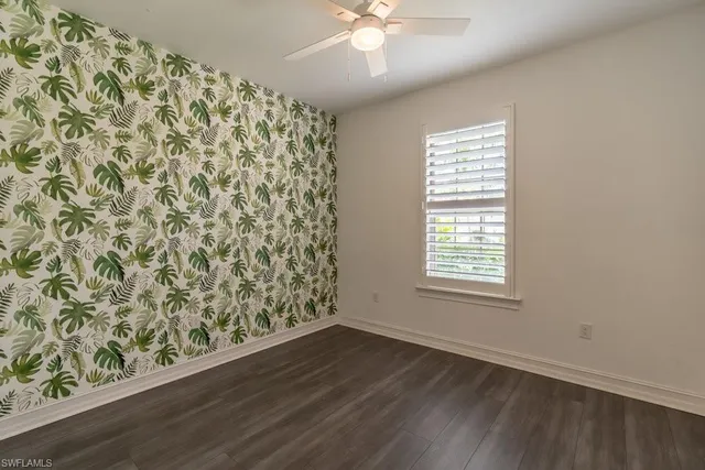 a bathroom with a granite countertop bathtub shower sink vanity mirror and toilet