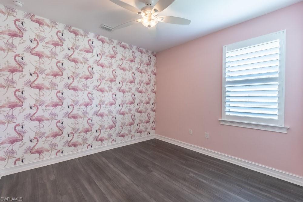 16374 Barclay Court Naples, FL 34110 - Photo 16 of 32 a view of a livingroom with wooden floor and a window