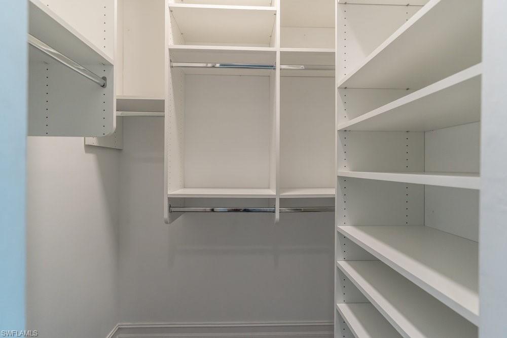 16374 Barclay Court Naples, FL 34110 - Photo 20 of 32 a view of an empty walk in closet