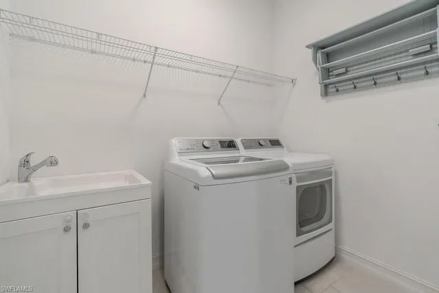 a view of an empty room with wooden floor and windows