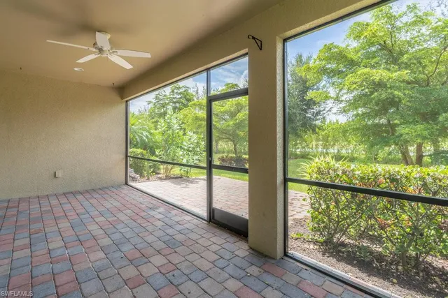 a view of a yard with plants and trees