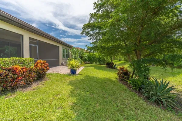 a backyard of a house with lots of green space and garden