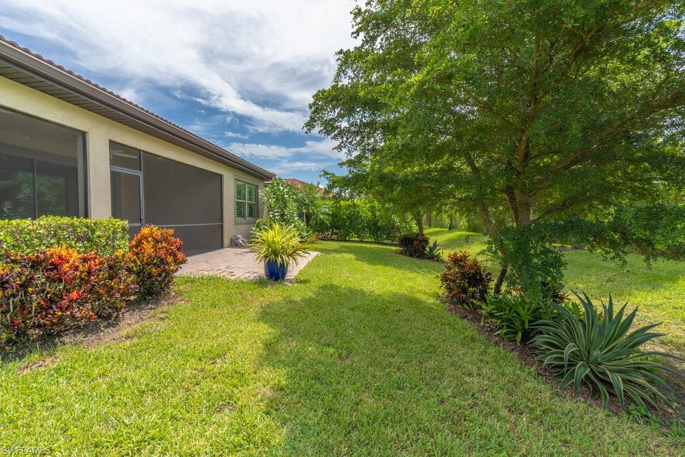 16374 Barclay Court Naples, FL 34110 - Photo 26 of 32 a front view of a house with garden
