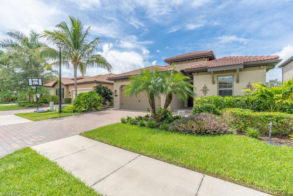 16374 Barclay Court Naples, FL 34110 - Photo 28 of 32 a view of a house with a yard and plants