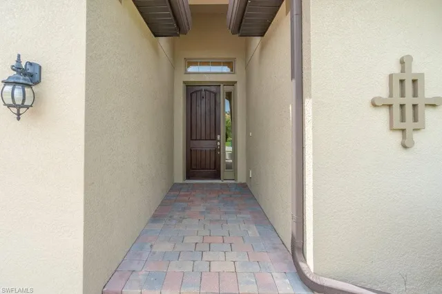 a view of a hallway with wooden floor and a bathroom