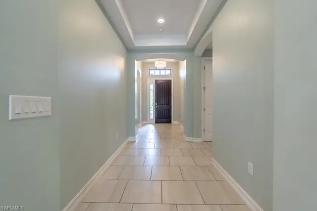 a view of hallway with a window and stairs