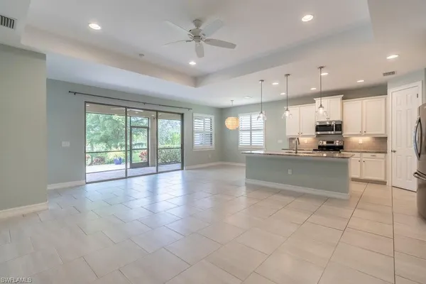 a kitchen with stainless steel appliances granite countertop a refrigerator a sink and a stove