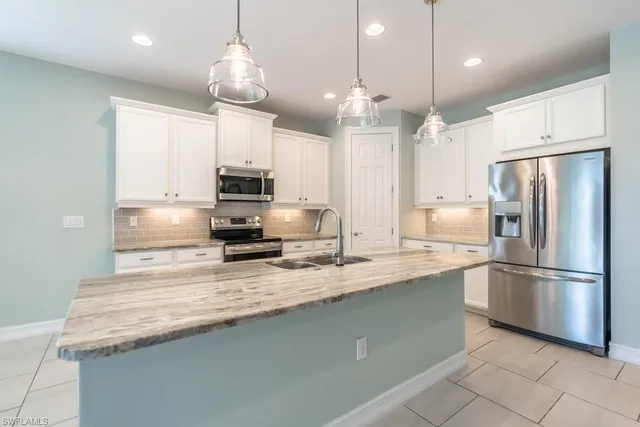 a kitchen with granite countertop cabinets and window