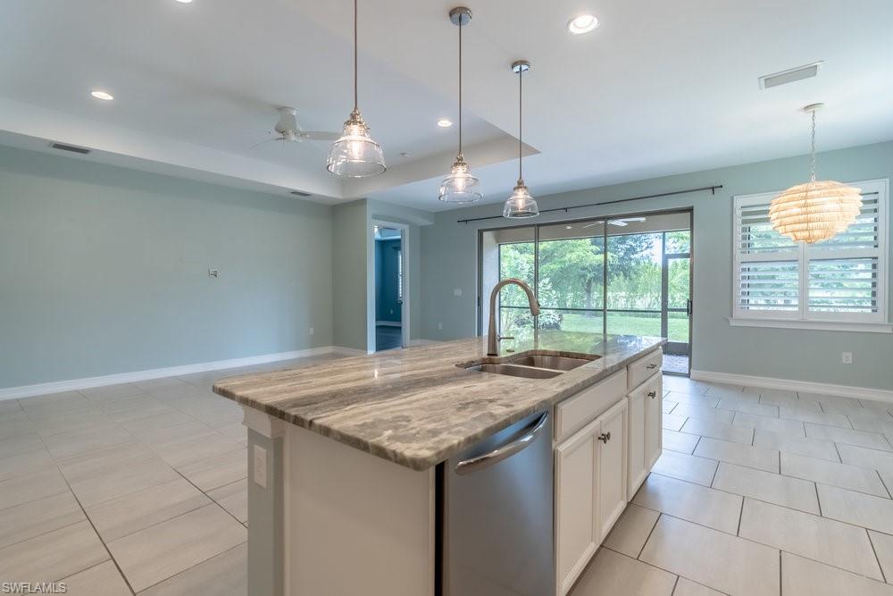 16374 Barclay Court Naples, FL 34110 - Photo 10 of 32 a kitchen with granite countertop cabinets and window