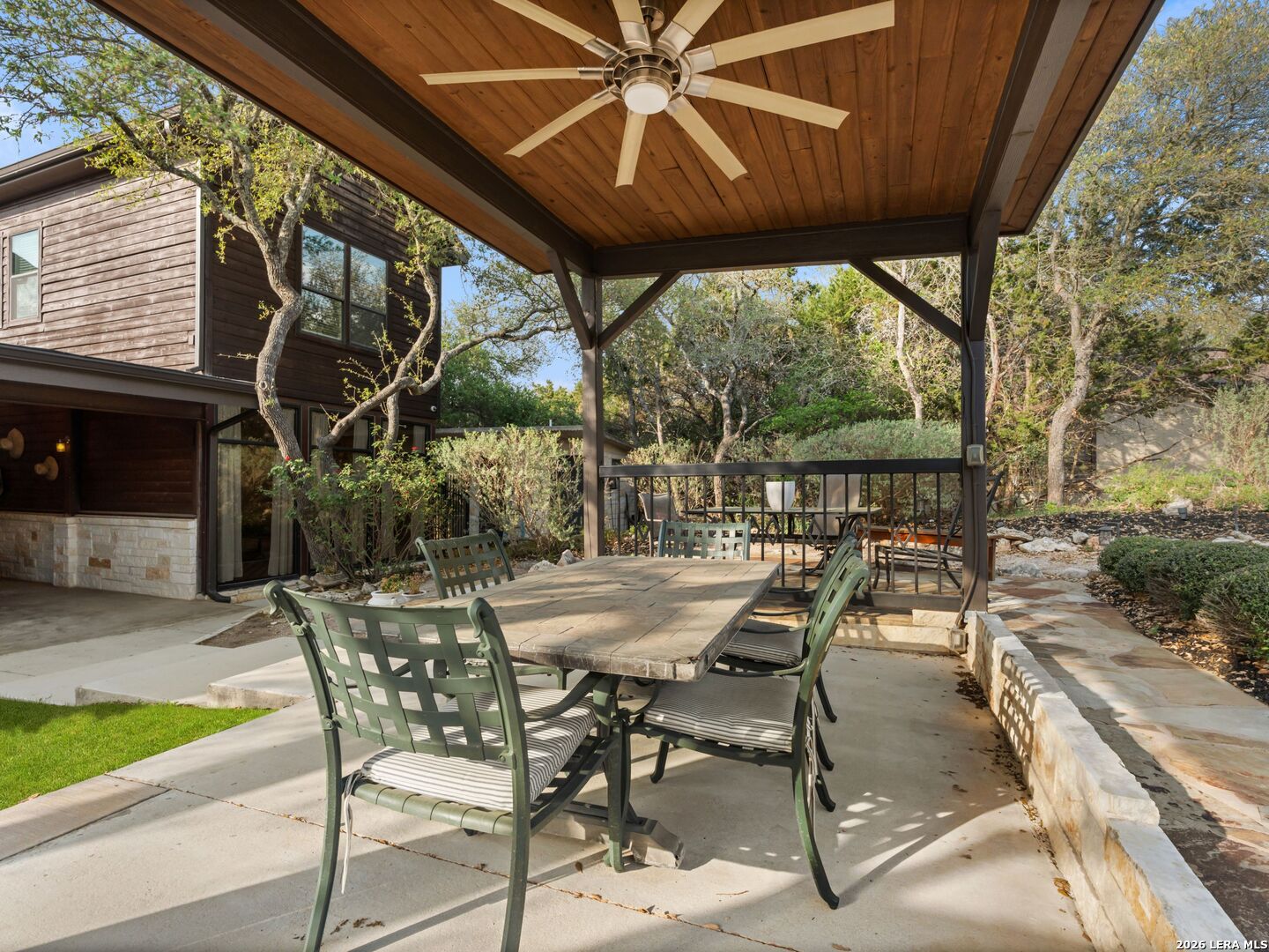 1146 Victoria Avenue Spring Branch, TX 78070 - Photo 48 of 89 a view of a patio with a table and chairs under an umbrella