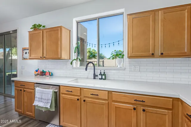 a kitchen with stainless steel appliances granite countertop a sink cabinets and a window