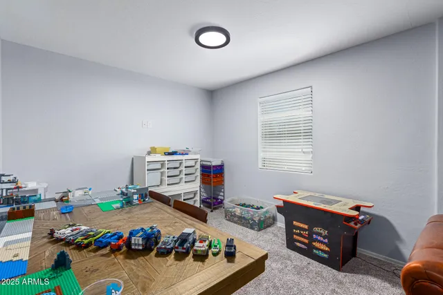 a children room with furniture and a window