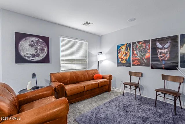 a blue couch sitting in a living room with furniture and window