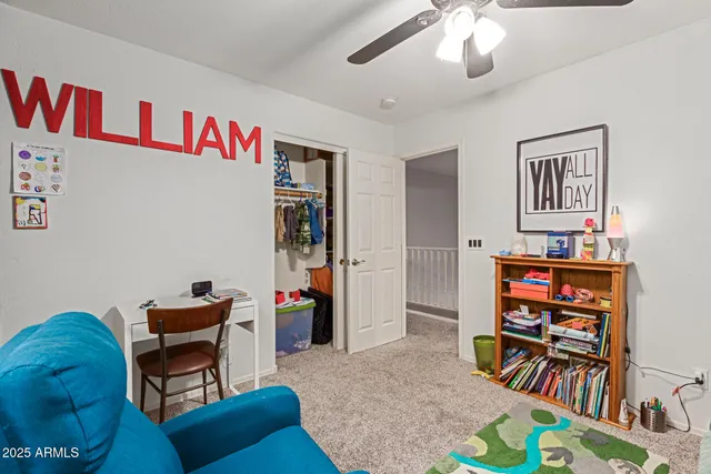a living room with furniture and a bookshelf