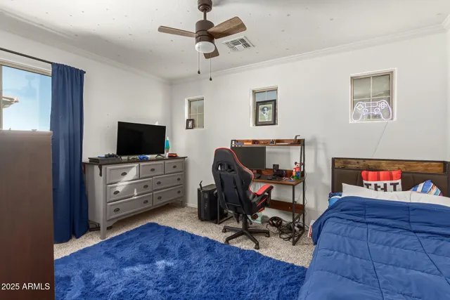 a view of a workspace with furniture and a flat screen tv