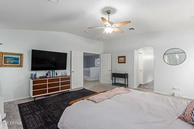 a bedroom with furniture and a flat screen tv