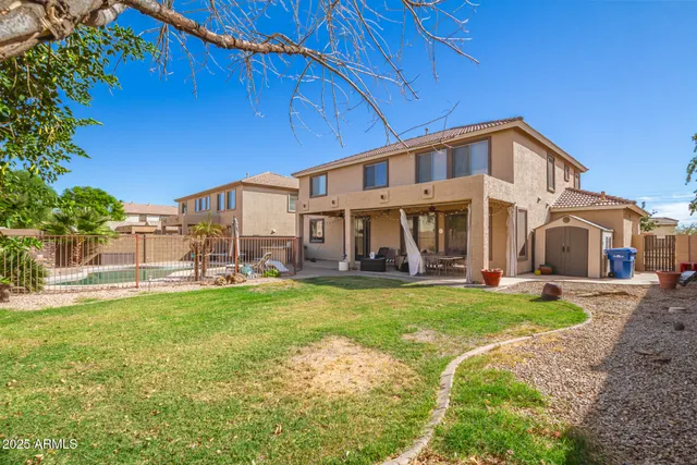 a view of a house with a yard and sitting area