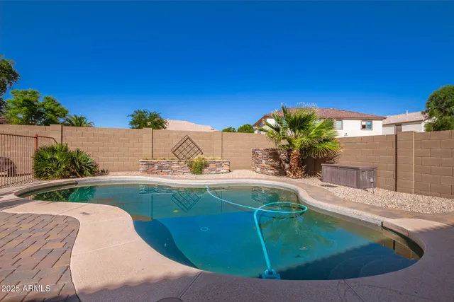 a view of a swimming pool with a yard
